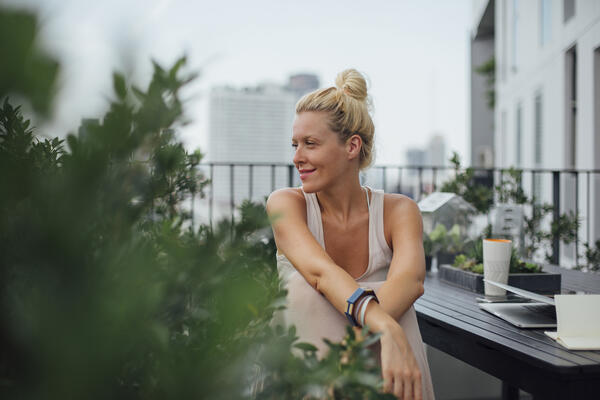 Woman stretching on balcony after a workout