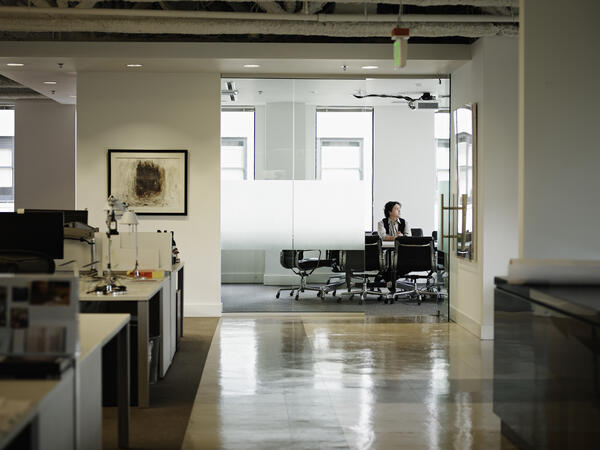 Distance shot of open concept office with people working in the background